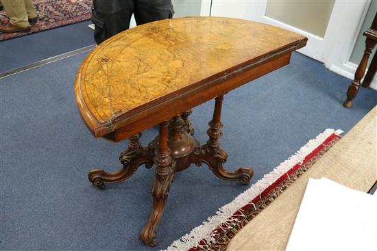 A Victorian walnut demi lune card table W.93cm